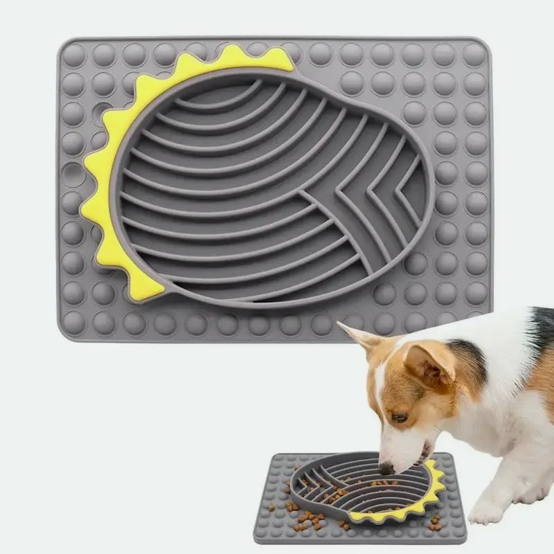 Grey silicone slow feeder with a corgi eating from one