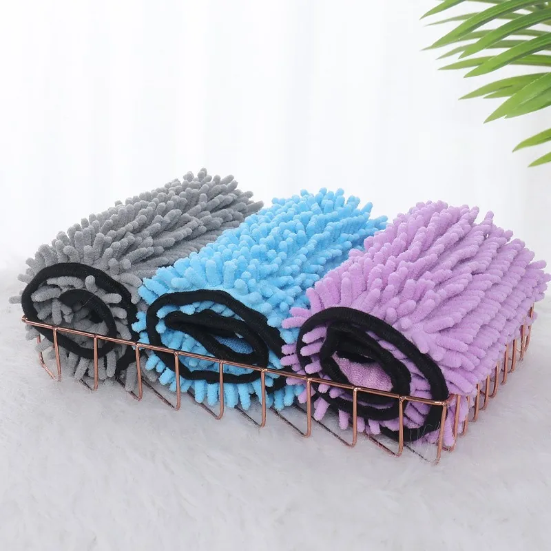 Rolled drying towels in grey, blue and purple in a wire basket
