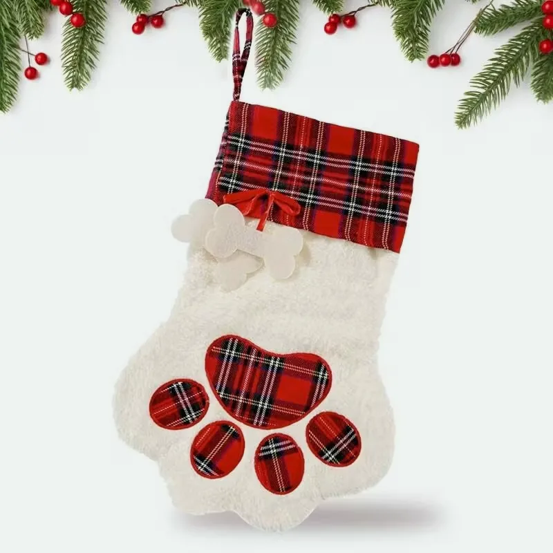 Paw-shaped cream plush Christmas stocking with a red tartan cuff