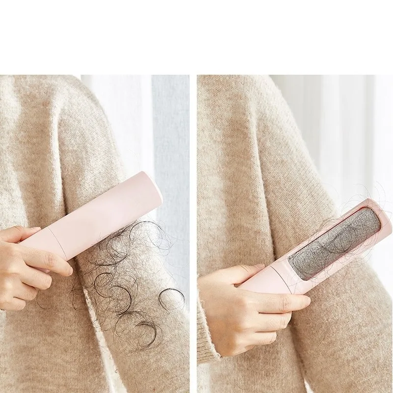 Hair remover being brushed over a knitted jumper, collecting hair