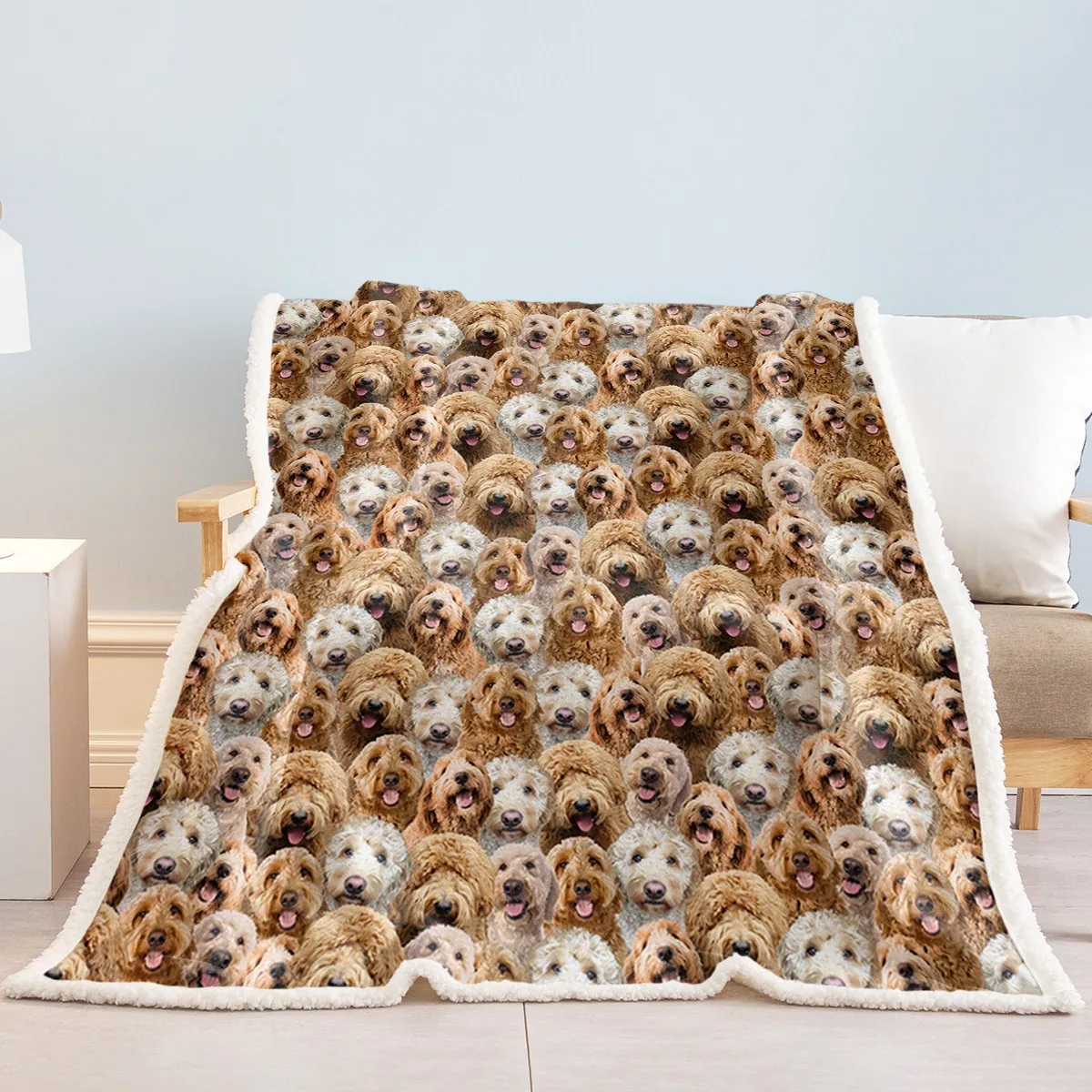 Fleece throw printed with cockapoo faces and edged with white sherpa, draped over an armchair