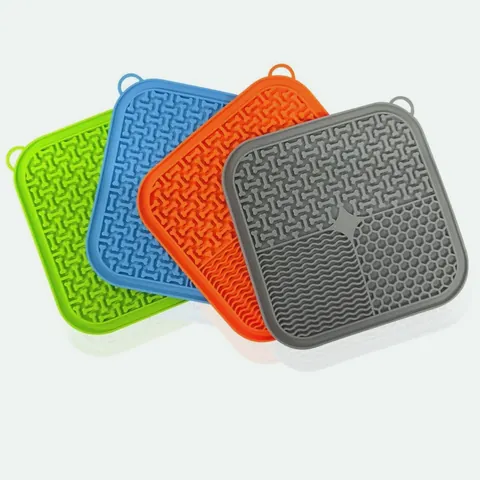 Silicone lick mats in green, blue, orange and grey, showing the colour range